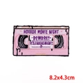 Macro shot of 8.2x4.3cm pink VHS horror movie night embroidered patch detail - Pink Tape-Horror Movie Night