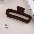 Detail of 13cm dark brown flocked hair claw clip with velvet texture and hollow design - 13cm Flocked Rectangular Claw Clip Dark Coffee