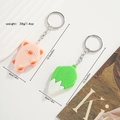 Detailed view of pink pig and green cabbage silicone keychains with size dimensions - Pig and Cabbage