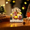 Glowing Christmas candy factory resin house ornament with warm LED lights - Gingerbread Man Shop Style
