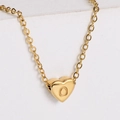 Macro view of a 18k gold-plated heart pendant with engraved letter O and fine link chain - Letter O