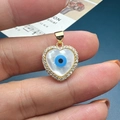 Macro shot of heart-shaped shell evil eye pendant with gold plating and zircons - Style D