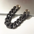 Macro detail of matte dark grey resin chain strap with gold metal buckles on desk - Dark Grey