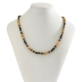 Macro detail of men's bohemian necklace with black cylindrical beads and brown wood texture - 05937 Black Cylindrical Beads & Light Brown Mix