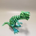Detailed view of green metallic 3D printed T-Rex skull with movable joints and stand - Cyan