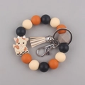 Detail of beaded keychain bracelet with orange silicone beads and cute cartoon goat charm - Goat Beige