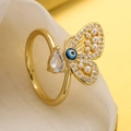 Macro shot of butterfly ring featuring evil eye motif and teardrop crystal detail - Purple Eye