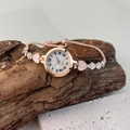 Detail of rose gold quartz watch with pink heart bracelet and Roman numerals - Rose Gold