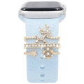 Close-up of gold reindeer and snowflake charms on light blue silicone watch band - Gold-Reindeer Snowflake Star-Blue Band