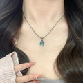 Silver snake chain necklace featuring a teardrop-shaped teal cat eye stone pendant - Ocean Blue Waterdrop