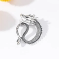Silver vintage dragon brooch with a white pearl accent on a minimalist white background - Antique Silver