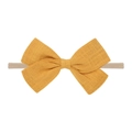 Detail of yellow cotton bow on nude elastic headband for babies with soft fabric texture - Yellow