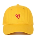 Close-up of red heart embroidery on yellow cotton baseball cap with textured stitching - Red Heart Embroidery / Yellow