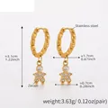 Detailed view of gold stainless steel twisted hoop earrings with zircon figure charm - Twisted Hoop Doll / Gold-Q135