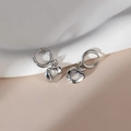 Silver apple-shaped earrings with leaf texture and round clasp on beige background - Steel Color - Apple Shape