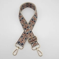 Detailed view of jacquard embroidered bag strap with golden metal hooks and adjustable buckle - Beige Brown Gold Hook