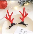 Pair of red reindeer antler hair clips on a tray with festive Christmas decorations - Simple Red Antlers Pair