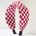 Detailed close-up of red and white checkered fabric headband with a top knotted design - Red