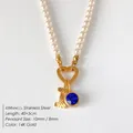 Elegant pearl necklace featuring a 14K gold letter L and blue gemstone pendant - Letter I