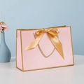 Pink paper gift bag with golden bow decoration and woven handles for jewelry packaging - XS (19x15x7cm) / Pink Gold Frame