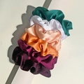 Detailed view of 5-piece satin scrunchies set in multi-colors stacked on a white cylinder - Classic Elegant Series