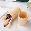 Beige PU leather makeup brush holder with 12 soft bristle brushes on marble background - 12Pcs Morandi Brushes With Storage Bucket
