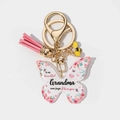 Macro shot of butterfly acrylic keychain with Grandma floral text and pink tassel - Grandma