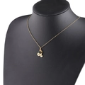 Golden Leo constellation necklace with green birthstone shown on a black mannequin bust - 5-5 Leo
