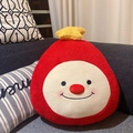 Detail of red plush ghost pillow with yellow star on a cozy sofa, soft material close-up - Red Elf (Pillow Style)