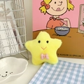 Detailed view of a soft yellow star plush keychain with a pink polka dot bow tie accessory - Yellow Star with Pink Bowtie