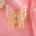 Detail view of a translucent champagne yellow butterfly hair claw clip on pink silk - 16# Light Gold Cutout Butterfly Claw Clip