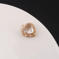 Macro shot of gold-plated 3D heart pendant featuring a large central zircon and halo setting - White