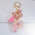 Pink resin letter P keychain with glitter, butterfly charm and leather tassel - Letter P