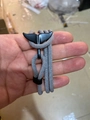 Grey woven rope bracelet with black whale tail clasp shown on person's wrist - Black Whale Tail Buckle / Light Gray