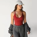 Deep red ribbed knit racerback tank top paired with grey joggers for a sporty look - Burgundy