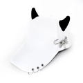 Close-up of white punk baseball cap featuring black demon horns and silver rings - Safety Pin Airplane White