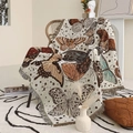 Detail of bohemian woven blanket with butterfly patterns and tassel edges on a chair - Butterfly Pattern (XT2022-3) / 130x160cm
