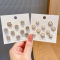Handheld display of elegant pearl and rhinestone decorative buttons on white cards - Rhinestone and Pearl Combination