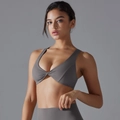 Detailed view of dark gray sports bra featuring a twisted knot design and deep V-neckline - Titanium Gray