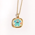 Close-up of golden enamel monster pendant with evil eye and star details - Blue Green Cartoon Monster (Style 5)