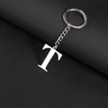 Polished stainless steel keychain with uppercase letter T pendant on dark leather - Letter T