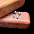 Macro shot of silver barbell cartilage earrings with round-cut cubic zirconia on wood - 3mm Barbell Style (Single) / Steel
