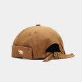 Detailed close-up of brown canvas docker hat with white bear embroidery and metal buckle - Adjustable / Caramel color