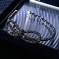 Macro shot of a black rhinestone bow headband with glittering stones and gold end caps - Knotted Full Grey Rhinestone Slim Headband