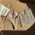 Detailed macro view of beige three-piece crochet mesh bikini with textured knit fabric details - Apricot