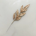 Detailed view of champagne gold glittery artificial branch for Christmas holiday decoration - Champagne
