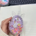 Detail of transparent unicorn hair brush with purple glitter and moving sequins - Pony Blowing Candles