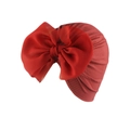 Detailed view of red ribbed knit baby turban featuring a large chiffon bow on white background - Wine Red