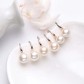Elegant white round pearl drop earrings with rose gold hooks on a white ceramic plate - White Gold / 6mm White Natural Pearl Earrings