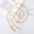 Detail of gold chain strap featuring pink enamel flowers and a white pearl charm - Gold Chain + Pink Flower